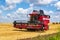 modern heavy harvesters remove the ripe wheat bread in field. Seasonal agricultural work