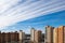 Modern high-rise architecture with scenic clouds on blue sky