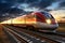 A modern high-speed train moves along the railway tracks in the evening against the backdrop of sunset. High-speed passenger rail