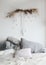 Modern home interior design. Cozy bed with wooden canopy and pillows, blanket. Bedroom interior, scandinavian style.