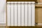 Modern home white radiator heating. Replacement, repair, installation of radiators, close-up photo.