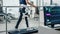 Modern Hospital Physical Therapy: Patient with Injury Walks on Treadmill Wearing Advanced Robotic