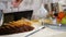 Modern hotel serves buffet for breakfast. catering concept. Female waiter putting piece of bread into steel bread basket