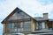 Modern house attic construction with roof guttering and panoramic mansard, attic skylight window.