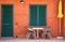 Modern house entrance colorful Italian with table and chairs and umbrella