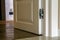 Modern house interior detail with wooden parquet floor and white door. Apartment after renovation close-up.