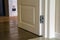 Modern house interior detail with wooden parquet floor and white door. Apartment after renovation close-up.