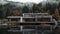 modern house at the lake, moody mountain forest background, water reflection