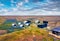 Modern icelandic building in volcanic desert among the field of blooming lupine flowers