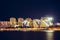 Modern illuminated buildings on night Gelendzhik city embankment with lights reflection in sea water