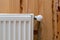 Modern individual radiator in room with wooden wall and cozy interior