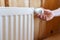 Modern individual radiator in room with wooden wall and cozy interior