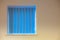 Modern interior design. Blue vertical blinds over window on yell