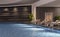 Modern interior design of indoor swimming pool with pool beds, night scene, hotel resort, spa, high contrast, dark, 3d