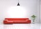 Modern interior design of living room with red sofa and plant pot on white glossy wooden floor. Turn on hanging lamp on wall. Home