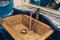 Modern interior design in public restaurant toilet. Vintage sink, tap with mirror and blue tile