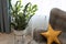 Modern interior in neutral colors, details. Geometric armchair with pillow in shape of star, rest area, potted plant. Children`s