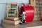 Modern interior study room with Workplace for school child. Desk in child bedroom. Red backpack, Books, abacus, figurine hare on w