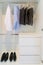 Modern interior wardrobe with man shirt, pants and shoes