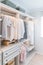 Modern interior wardrobe with shirt and dress in shelf