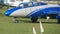 Modern jet airplane riding on green grass at airport. Close up of small plane preparing to taking off