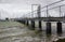 The modern jetty with a walkway to the deep water channel at Warsash in Hampshire in the South of England.