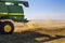 Modern John Deere combine harvesting grain in the field