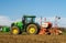 Modern John Deere tractor drilling seed in field