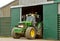 Modern John Deere tractor parked in barn