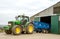 Modern John Deere tractor parking blue trailer