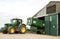 Modern John Deere tractor parking green trailer