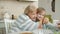 Modern kid girl taking selfie with loving grandmother using smartphone posing for camera hugging