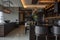 modern kitchen bar with elegant lighting and dark wood finishes, chairs and a marble floor creating a warm and inviting