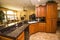 Modern Kitchen With Black Granite Counter Top & Rich Wood Cabinets