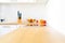 Modern kitchen counter with induction hob, fresh fruit and homemade lemonade