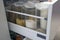 Modern kitchen countertop with food ingredients. Top view of drawers with spices organized inside. Jars with food in the