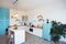 Modern Kitchen Interior with Island, Sink, Cabinets, and Big Window in New Luxury Home.