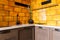 Modern kitchen interior, ocher tiles, wooden furniture made of natural wood.
