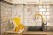 Modern kitchen interior with white tile and facades and yellow faucet