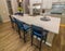 Modern Kitchen Island With Blue Cushion Bar Stools & Decorator Items