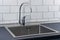Modern kitchen metal faucet and stainless steel sink.