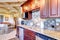 Modern kitchen room with mahogany storage combination .