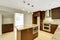 Modern kitchen room with matte brown cabinets and granite trim.