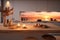 A modern kitchen with a sunset ocean view, illuminated by natural light and warm candle glow