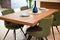 Modern kitchen, wooden walnut dining table and green chairs