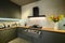 Modern large luxury dark gray kitchen with pulled out drawer