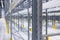 Modern large warehouse space interior, new and modern distribution storage with rows of empty high shelves and racks, concrete and