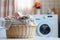 Modern laundry room featuring a high-tech washer and a wicker laundry basket