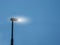 Modern LED energy saving lamp in a street on a metal pole against blue color sky. Illuminating streets concept. Technology and