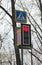 Modern LED traffic light glows red and the pedestrian crossing s